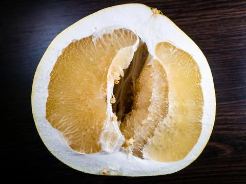 Cut in half the pomelo fruit on a dark background Stock Photos