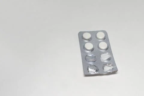 Cut into a half transparent packaging of white tablets antibiotic Stock Photos