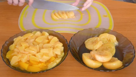 Cut into halves of peach and put in a plate Stock Footage 109373535