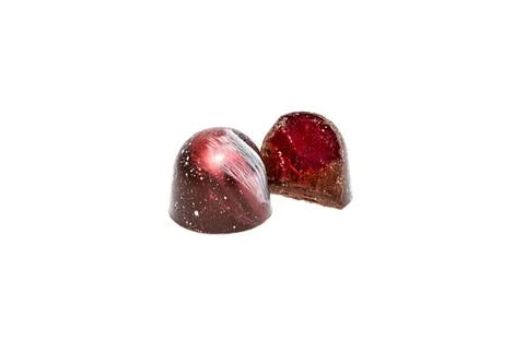 Cut handmade chocolate candy with cherry filling isolated on white background Stock Photos