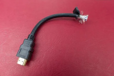 Cut hdmi cabel on ared background Stock Photos
