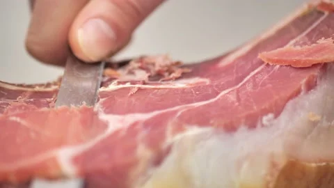 Cut juicy appetizing jamon, close-up. Spanish jamon. Video stock 231171508