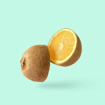 Cut kiwi fruit and inside an orange. Joke minimal pop art surprise fun poster 写真素材