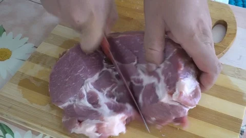 Cut a large piece of raw pork C5001 4k Stock Footage 112832636