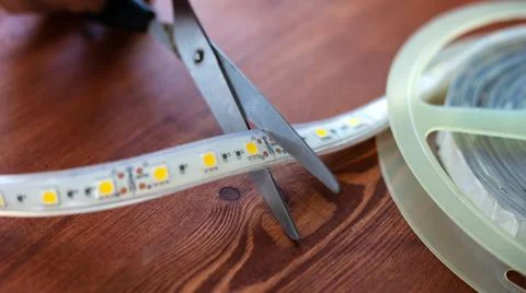 Cut the LED strip with scissors closeup Stock Photos
