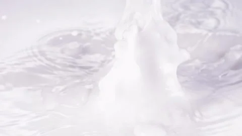 Cut the lemon and drop it into the milk，slow motion Video stock 248406795