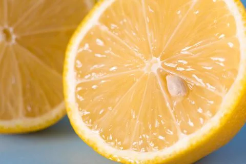 Cut lemon on blue background. Close up. Macrophotography. Stock Photos