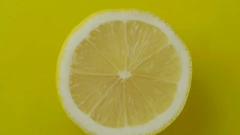 The cut lemon rotating on a yellow background Stock Footage 72530800