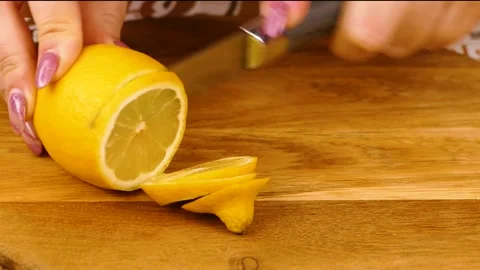 Cut An Lemon Into Slices on a plank Stock Footage 233620668