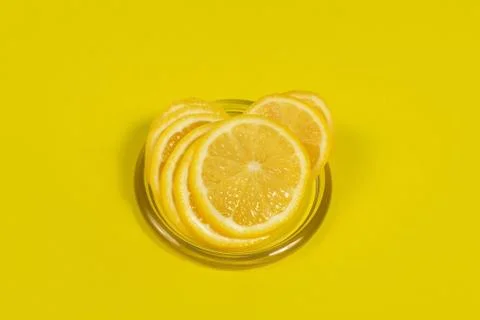 Cut lemon on a yellow background Stock Photos