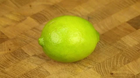 Cut lime and squeezes juice Stock Footage 72769876