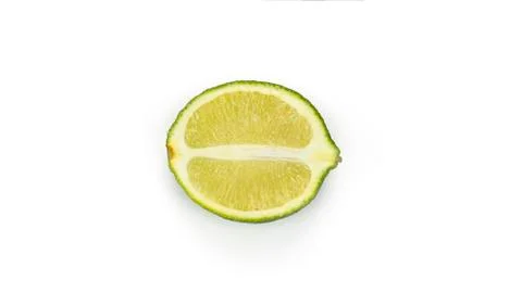Cut lime on a white background. Macro photo. Stock Photos