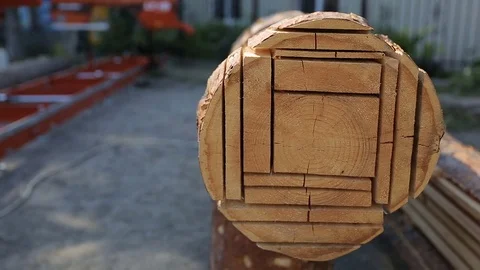 Cut log in planks using modern sawmill. Different size of boards cutted out deck Stock Footage 72670705