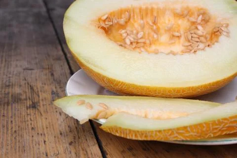 Cut melon on plate Stock Photos