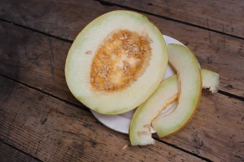 Cut melon on plate Stock Photos