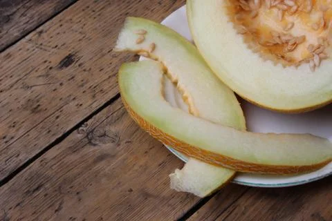 Cut melon on plate Stock Photos