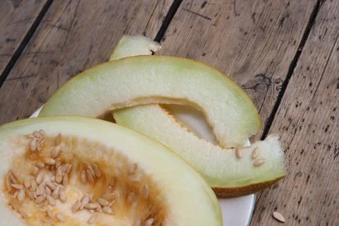 Cut melon on plate Stock Photos
