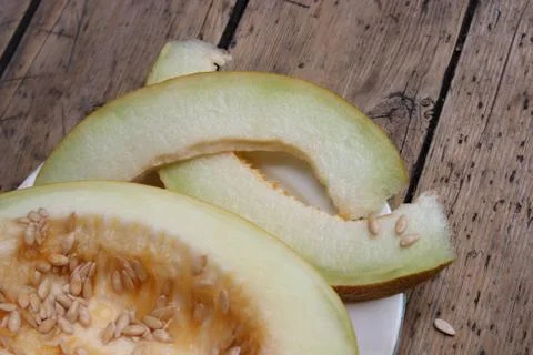 Cut melon on plate Stock Photos
