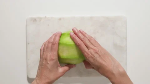 Cut the melon into slices and cubes. Fruit salad recipe Stock Footage 136713295