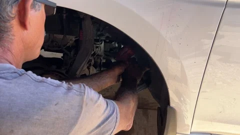 Cut Metal with Grinder to fix Front Inner Tie Rod End Auto Mechanic Repair Car Stock Footage 295570609