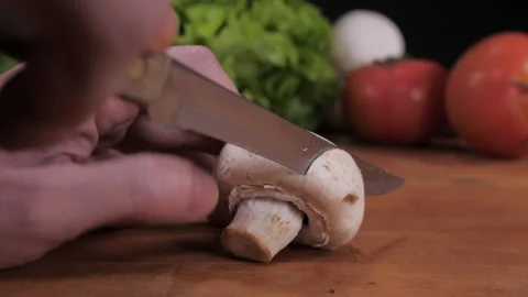 Cut mushroom with knife on kitchen table 4k Stock Footage 148313764