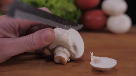 Cut mushroom with knife on kitchen table Stock Footage 148334858