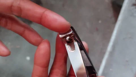 Cut the nail of the middle finger Stock Footage 262542050