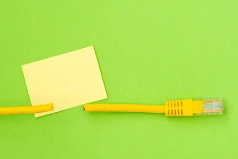 Cut network cable and blank sticky note Stock Photos