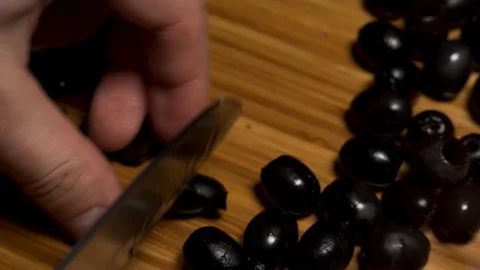  Cut olives with a large knife. Stock Footage 104657490