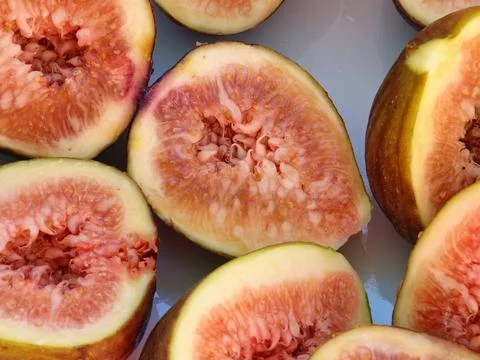 Cut Open Common Figs Showing Red Flesh and Seeds Stock Photos