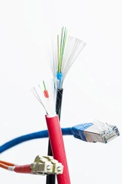A cut open network cable with RJ45 connector and a cut open optical fibre Stock Photos