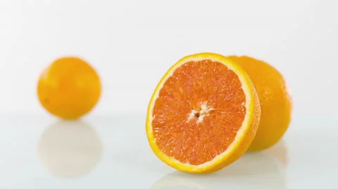 Cut orange isolated on white table Stock-Footage 66342968