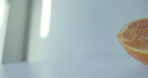 Cut Orange white background tabletop Stock Footage 128097516