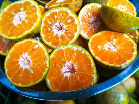 Cut oranges for juice Stock Photos