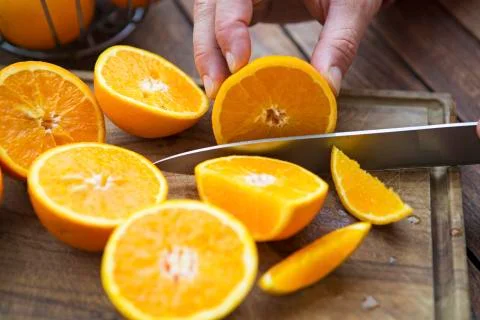Cut oranges with knife on table 스톡 사진