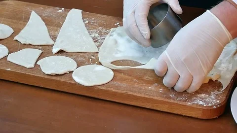 Cut out circles from raw cookie dough rolled seam on a wooden board Видео 74948763