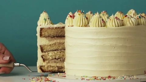 Cut out a slice of a birthday cake using knife and spatula Stock Footage 229324793