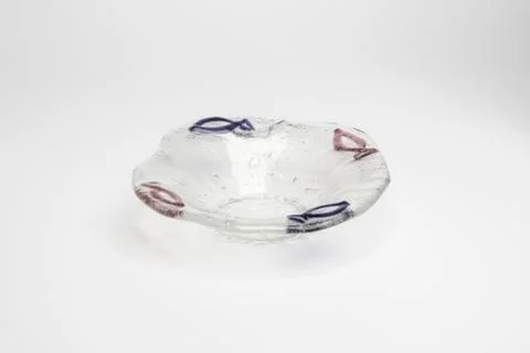 Cut-out of Tiny Crystal Ashtray with Purple and Brown Fish Design Stock Photos