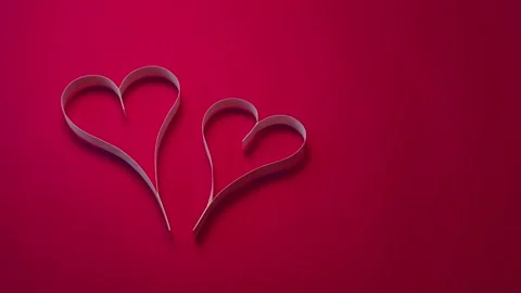 Cut paper hearts on red background. Stock Footage 85698004