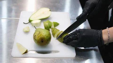 Cut a pear Hands slicing a pear with a knife Stock Footage 284436784