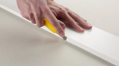 Cut a piece of drywall Stock Footage 60406640