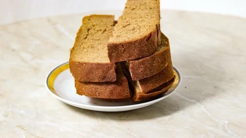 Cut pieces of black bread are placed on a plate Stock Footage 159676936