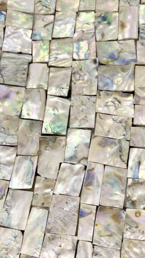 Cut pieces of nacre from abalone shell glued together for abstract art Stock Footage 343896321