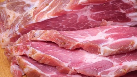 Cut pieces of steak rotate on the table close-up Stock Footage 221097243