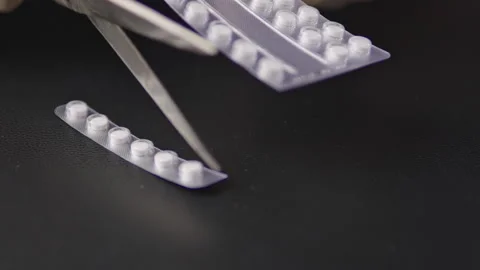 Cut pills with scissor Method of partitioning medicines using lighting effects Stock Footage 329171359