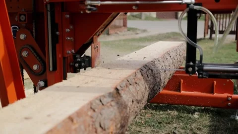 Cut pine tree log on sawing machine at wood production factory. Timber material Stock Footage 273920445