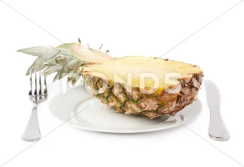 Cut pineapple on plate isolated over white background Stock Photos