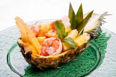 Cut pineapple stuffed with rice and Royal shrimps. On white background Stock Photos