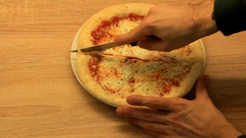 Cut the pizza with a knife Stock Footage 86573112