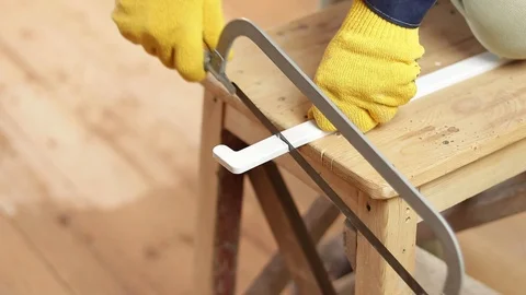 Cut the plastic corner with a hacksaw. Cut with a hacksaw for metal. Stock Footage 129411116